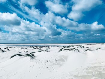 Scenic view of snow covered landscape against blue sky