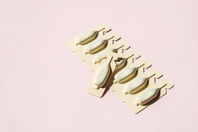 Suppositories in blister packaging arranged on pink. medical and pharmaceutical concepts.