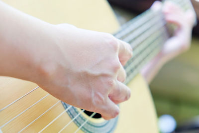 Cropped image of man playing guitar