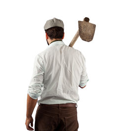 Rear view of man holding hat against white background