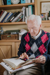 Full length of man reading book