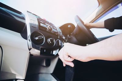 Cropped hands of man driving car