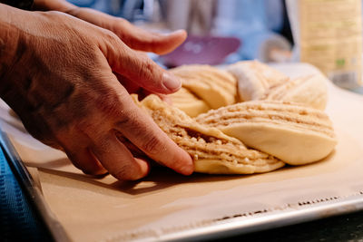 Close up of human hand preparing cake dough