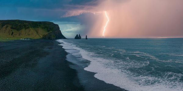 Iceland black sand beach with huge waves at reynisfjara vik.