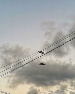 Low angle view of silhouette cranes against sky