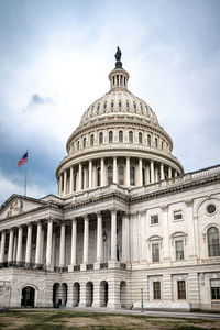 Facade of the united states capitol building in washington, d.c. on a cloudy and moody day. 