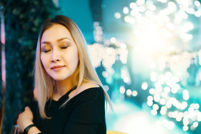 Portrait of beautiful young woman with eyes closed