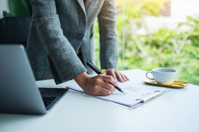 Midsection of business colleagues working at office