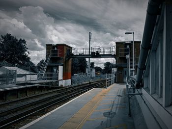 Train in railroad station against sky