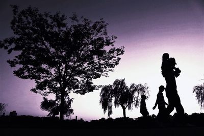 Silhouette of people at sunset