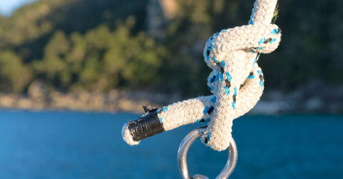 Close-up of blue rope tied to metal