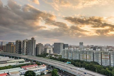 High angle view of city street and buildings against sky