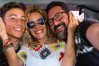 Portrait of smiling family in land vehicle