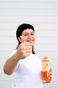 Portrait of a smiling young woman holding ice cream