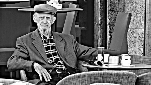 Rear view of man looking at camera