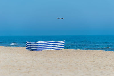 Beach screen on the polish beach on a sunny summer day in the background beautiful sea and gulls.