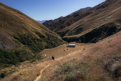 Scenic view of road by mountains against sky