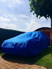 Tent on landscape against blue sky