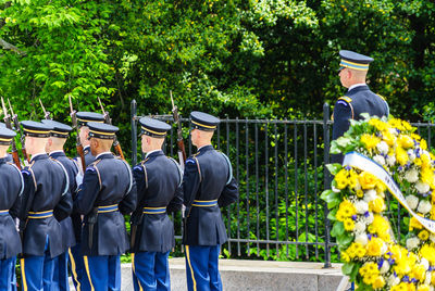 Rear view of honor guards standing by trees