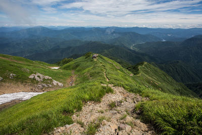 High angle view of green landscape against sky