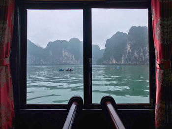 Scenic view of river seen through window