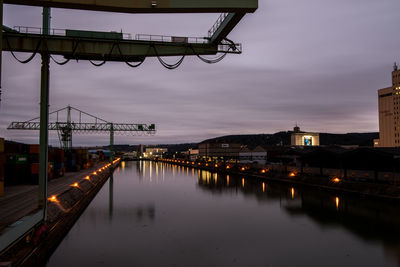 View of illuminated bridge over river in city