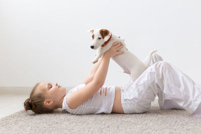 Side view of dog lying on blanket