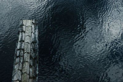 High angle view of wooden post in lake