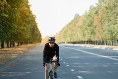 Man riding bicycle on road