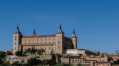 Low angle view of buildings against blue sky