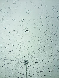 Low angle view of raindrops on window