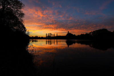 Scenic view of lake against orange sky