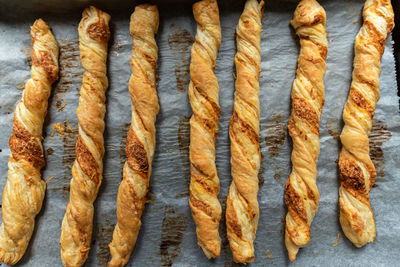 Freshly baked, crispy, puff pastry sticks on . perfect for a party.