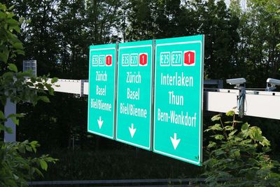 Close-up of information sign against trees