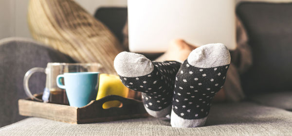 Low section of person sitting on bed