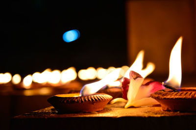 Close-up of lit candles against blurred background