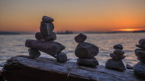 Stones on beach at sunset