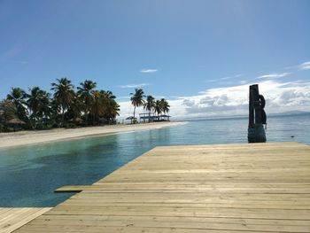 Scenic view of swimming pool by sea against sky