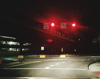 Illuminated road sign at night