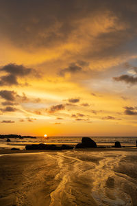 Scenic view of beach against sky during sunset