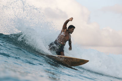 Surfer on a wave at day time