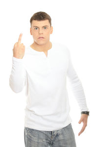Portrait of young man standing against white background