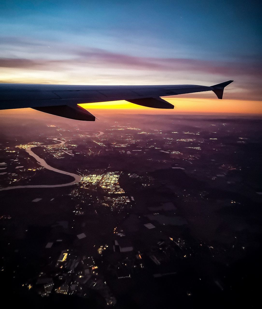 AIRPLANE FLYING IN SKY DURING SUNSET