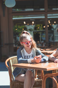 Woman sitting on table at cafe