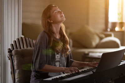 A young woman playing the piano creative, performance, musical concept, she wearing a t-shirt