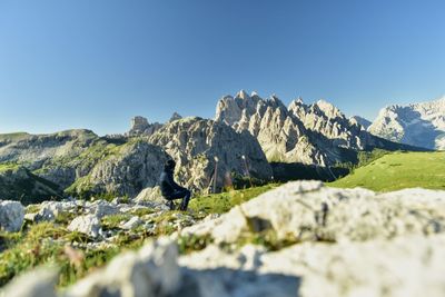 Scenic view of rocky mountains against clear blue sky