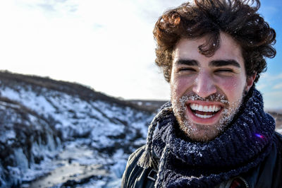 Portrait of smiling man standing in snow