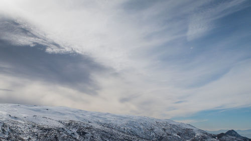 Low angle view of snowcapped mountain against sky