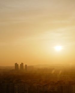 Silhouette buildings against sky during sunset