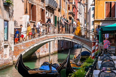 Traditional gondolas on the narrow canal in venice, italy.